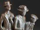 This sculpture is a take on 'The Seven Ages of Man'. The Baby, who is trying to stand up is wearing a bobble hat. He holds the hand of the Young Boy, looking back at his babyhood and wearing his school cap. The Teenager, in a hurry to start his life, wears a baseball cap backwards. The Student, wondering what his future holds, wears a mortar board. The Business Man, looking very important and successful is in a bowler hat. The Retired Man in his comfortable home clothes wears a homberg hat and is looking down at his future, which is an Old Man in his cloth cap, holding his painful back, wondering what is to come! 
 The curved base is shaped to show life moving forward and then tailing off towards old age with the figures are all linked together as they move through life. The paternation goes from pale to dark bronze as they progress. 